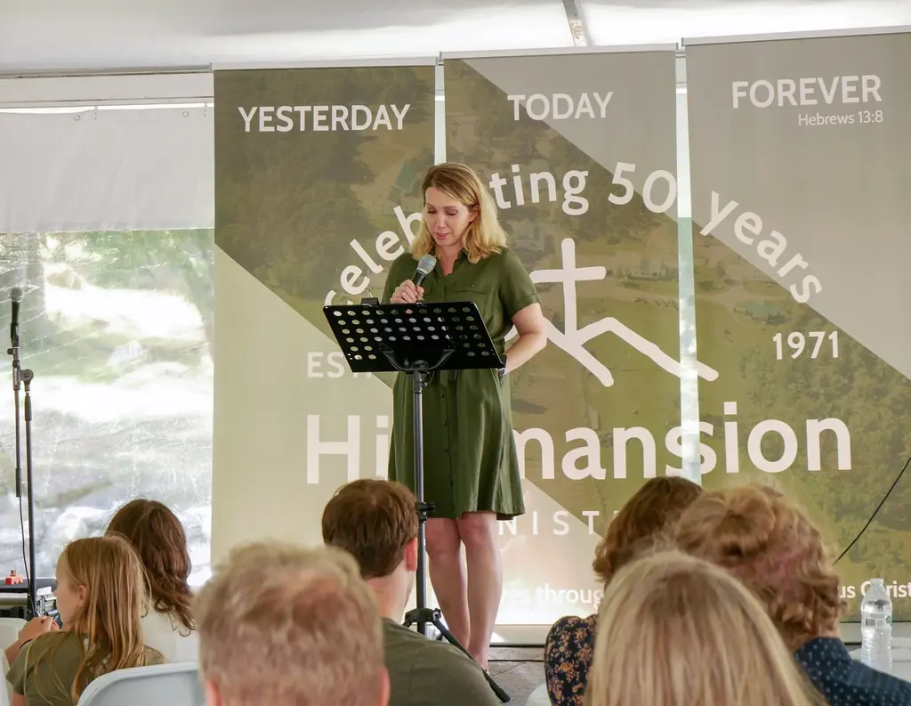 Monica Church sharing her testimony at the 50th Anniversary
