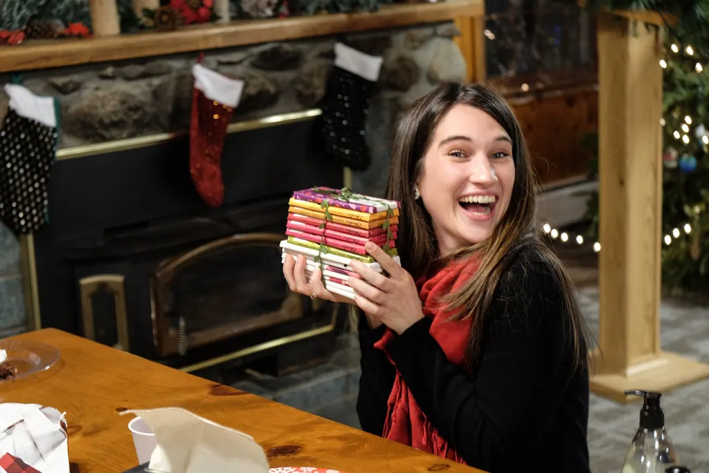 Sara, a Servant Leader, receiving a gift on Christmas Eve